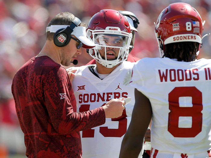 Oklahoma coach Lincoln Riley talks to QB Caleb Williams